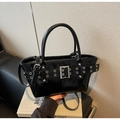 Detail of black glossy tote bag featuring silver eyelet belt and square metal buckle - Black