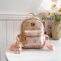 Pink mini backpack with teddy bear prints and plush charm on white marble table - With Charm / Pink