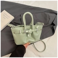 Close-up of mint green handbag featuring silver buckle and elegant pleated texture - Green