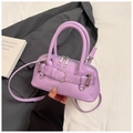 Close-up of lavender shell bag with strap detail and textured leather finish - Purple