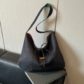 Large dark blue denim crossbody hobo bag with drawstring and colorful patterned strap - Pocket Style