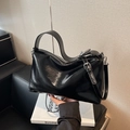 Glossy black patent leather pillow bag with wide handle and metallic buckle detail - Black