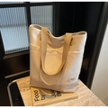 Detail of canvas tote bag with khaki handles and pink good luck bubble logo on marble - Off-white