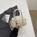 Chic beige lychee leather satchel with silver heart pendant and adjustable strap - Off-white