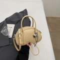 Creamy beige crossbody pillow bag with lychee texture and heart metal pendant charm - Yellow