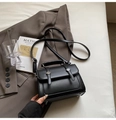 Classic black leather handbag with silver buckles and adjustable strap on a grey suit - Black without Pendant