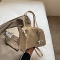 Chic beige patent leather Boston bag with lace bow and silver balloon dog charm - Khaki