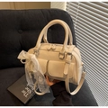 Detail view of cream Boston bag featuring side lace bow and pearl charm accents - Off-white