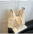 Detail of beige corduroy hobo tote bag with adjustable strap and small matching pouch - White
