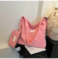 Close-up of pink corduroy tote bag set with matching pouch and white logo patch - Pink