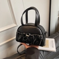 Minimalist black shell crossbody handbag with pleated detail and silver metal buckle - Black