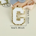 Detailed view of chenille letter C patch with gold glitter edge and white towel texture - Letter C / White / Hot Melt Adhesive