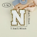 Detail of chenille letter N patch with gold sequins, measuring 8cm by 7.5cm - Letter N / White / Hot Melt Adhesive