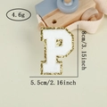 Macro shot of gold sequin letter P patch with white embroidery for DIY decor - Letter P / White / Hot Melt Adhesive