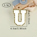 Macro shot of letter U chenille patch with gold sequins and 8cm size dimensions - Letter U / White / Hot Melt Adhesive