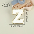 Detailed view of chenille letter Z patch with gold sequins and 8cm size dimensions - Letter Z / White / Hot Melt Adhesive