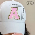 Detailed view of pink chenille letter A patch with gold glitter on a white baseball cap - Letter A / Pink / Hot Melt Adhesive