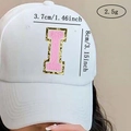 Detailed size view of chenille letter I patch on a white cap with pink sequins - Letter I / Pink / Hot Melt Adhesive