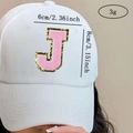 Detail of pink chenille letter J patch with gold glitter on white baseball hat - Letter J / Pink / Hot Melt Adhesive
