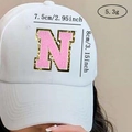Detail of pink chenille letter N patch with gold sequins on white baseball cap - Letter N / Pink / Hot Melt Adhesive