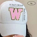Detail of pink chenille letter W patch with gold sequins on white baseball cap - Letter W / Pink / Hot Melt Adhesive