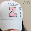 Detail of white baseball cap with pink chenille letter Z patch and gold glitter border - Letter Z / Pink / Hot Melt Adhesive