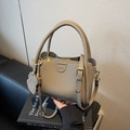 Elegant khaki grey litchi grain leather bucket bag with fashion label and dog charm - Gray