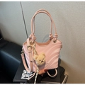Pink shoulder bag detail showing wave texture, cylindrical handles, and a cute teddy charm - Pink with Pendant