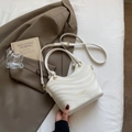 Chic beige crossbody bag featuring wave textures and metallic top handle on a blazer - Off-white Without Pendant