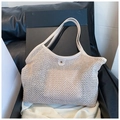 Detail of cream woven tote bag featuring leather trim and a golden buckle closure - One Size / Off White