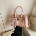 Pink minimalist crossbody bag with top handle, pearl charm and lace bow detail - Pink (With Pendant)