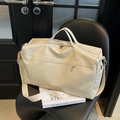 Close-up of cream PU leather tote bag with sturdy handles and adjustable shoulder strap - Off White