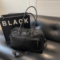 Large black faux leather travel bag with adjustable strap and minimalist white logo - Black
