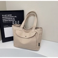 Detail of canvas tote bag showing functional front pocket and side storage compartment - Beige Grey