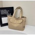 Detail view of khaki canvas tote bag featuring side pockets and metal snap button pocket - Khaki