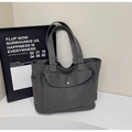 Detailed view of dark grey canvas tote bag with metal buckle flap pocket and side compartments - Dark Brown