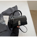 Close-up of a black glossy leather handbag with a silver square metal clasp and top handle - Black without Pendant