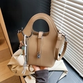 Khaki pebbled leather bucket bag with silver lock and dog charm in hand - With Pendant / Khaki