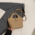 Camel leather bucket bag with silver padlock and round cutout handle in elegant scene - No Pendant / Khaki