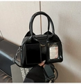 Close-up of black glossy bowling bag with twin handles and transparent card pocket detail - Black