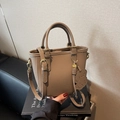 Khaki pebbled leather bucket bag with top handle, crossbody strap and cute puppy charm - Gray