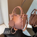 Pink lychee-patterned leather bucket bag with cute dog charm and dual top handles - Pink