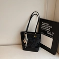 Black embossed leather tote bag with elegant golden hardware and stylish side charm - With Charm / Black