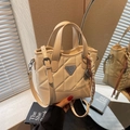 Quilted beige tote bag with triangular metal logo and woven charm detail - Cream White With Pendant