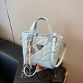Quilted light blue handbag with triangle logo and tennis racket charm accessory - Blue with Charm