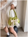Detail of green corduroy handbag with a large creamy white satin bow decoration - Green