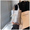 Detailed macro view of a silver metallic mini bucket bag featuring a pearl bow charm - Pearl Bow Silver Metallic Style / Silver