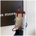 Close-up of silver mini tote with red handles and white pearl bow pendant charm - Pearl Bow Contrast Color Style / Silver and Red