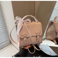 Detail of pink glossy leather backpack with decorative bows and white lace handle - Pink