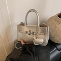 Modern silver metallic bucket bag with textured heart charm and dual handles style - With Charm / Silver